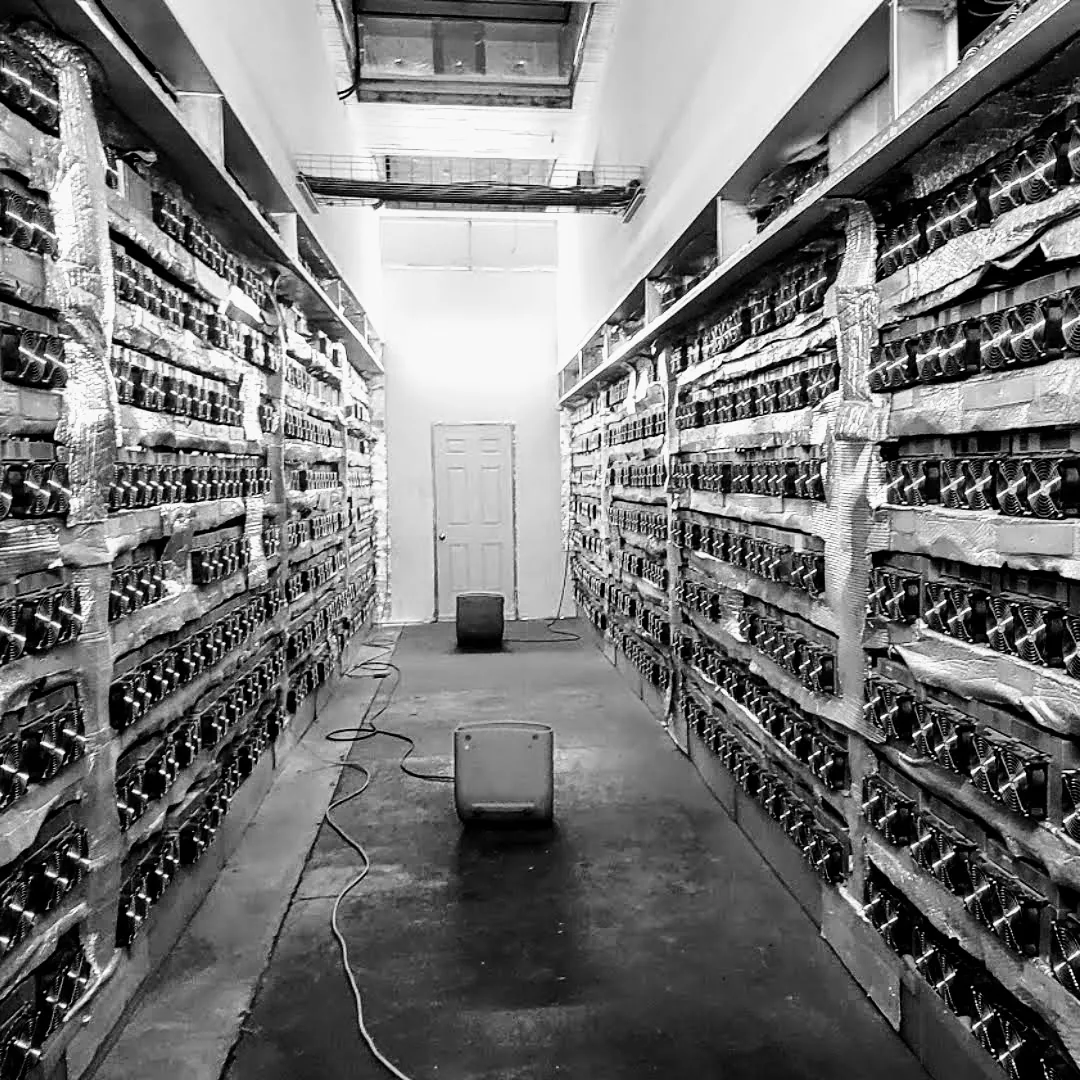 Air-cooled rack aisle of Bitcoin miners in our Quebec facility
